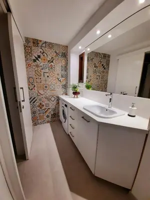 a bathroom with a sink and a washing machine at BELLE VUE Mountain Home in Kalopanayiotis