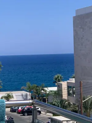 a view of the ocean from the balcony of a building at One-bedroom beach apartment, 30m from an amazing beach, Coralli in Protaras