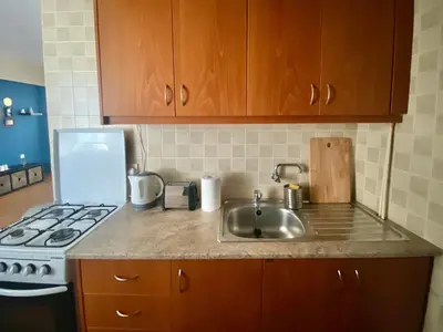 a kitchen counter with a sink and a stove at Aphrodite Sea View Apartment in Larnaka