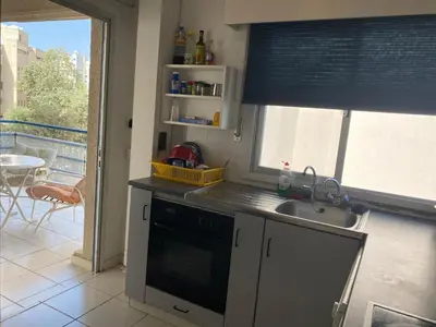 a kitchen with a sink and a stove and a window at private room in a shared flat at best location in Limassol