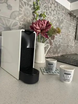 a black and white microwave on a counter with two cups at Lovely 1-bd apt with patio in Nicosia center in Nicosia
