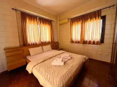a bedroom with a bed with two towels on it at STAY Pernera House in Ayia Napa
