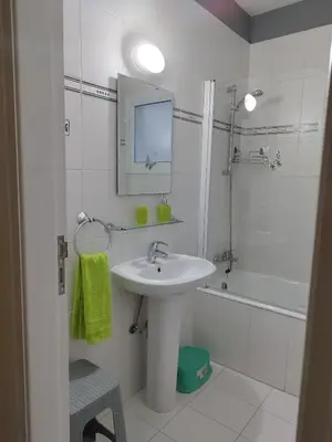 a white bathroom with a sink and a mirror at Panorama Village Complex in Paralimni
