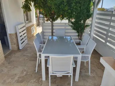a blue table and chairs on a patio at Protaras sea view Villa with private pool in Protaras