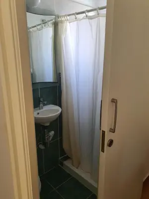 a bathroom with a white shower curtain and a sink at Protaras sea view Villa with private pool in Protaras