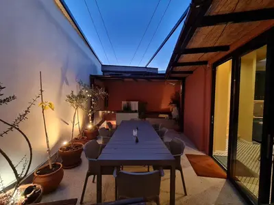a dining room with a table and some plants at Selin the stone house in Limassol