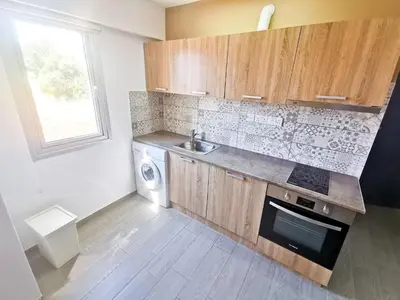 a kitchen with a sink and a washing machine at Hidden Gem City Studio in Larnaka