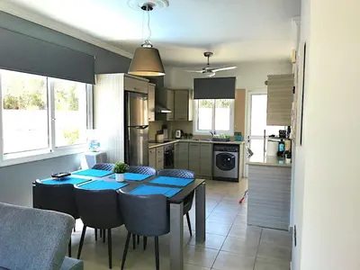 a kitchen and dining room with a table and chairs at Villa Alba, Luxury 4 BDRM Villa with Heated Pool in Protaras