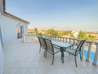 a patio with a table and chairs on a balcony at Grand villa Lynn seaview Ayia Napa in Ayia Napa