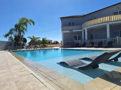 a swimming pool with a shark statue in front of a house at Grand villa Lynn seaview Ayia Napa in Ayia Napa