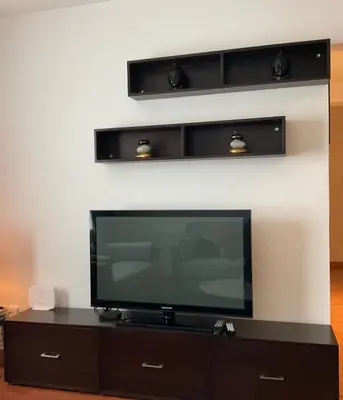 a flat screen tv sitting on top of a entertainment center at StayCity Flat!!! in Nicosia