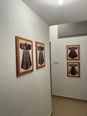 three framed pictures of dresses on a wall at ARTEMIS 1 Bdr Down Town Nicosia in Nicosia
