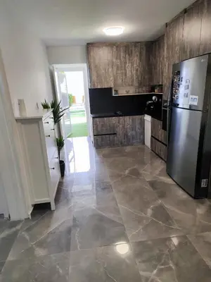 a kitchen with a refrigerator and a tile floor at Pampering Beach Dream, A Stunning Luxury Retreat at Yialos Village in Meneou