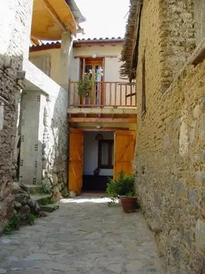 an alley between two buildings with a balcony at The Mill Hotel in Kakopetria