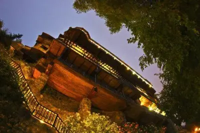 a wooden bench sitting on top of a hill at The Mill Hotel in Kakopetria