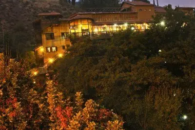 a house on top of a hill with lights at The Mill Hotel in Kakopetria
