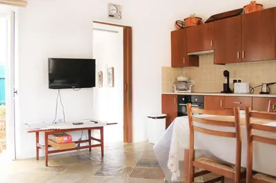 a kitchen with a table and a tub in a room at I Plateia in Kalopanayiotis