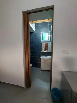 a bathroom with a sink and a toilet and a mirror at Anna Guesthouse 10 min walk from the beach in Larnaka