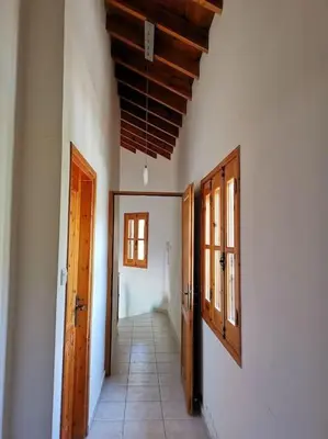 an empty hallway with wooden doors and a tile floor at Unique Stonehouse Traditional Villa in Ayia Anna in Ayia Anna