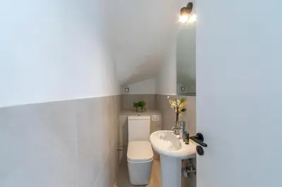 a white bathroom with a toilet and a sink at Ayia Napa Marina Vibes in Ayia Napa