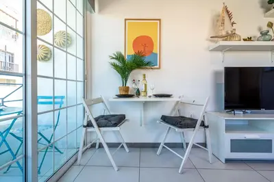 a room with a desk and chairs and a tv at Sofia's Cosy Studio in Larnaca in Larnaka