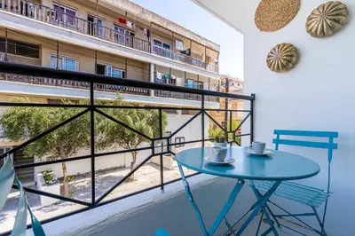 a balcony with a table and a view of a building at Sofia's Cosy Studio in Larnaca in Larnaka