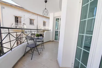 a balcony with two chairs and a table at Jana's 2-BR Apartment in Larnaca in Larnaka