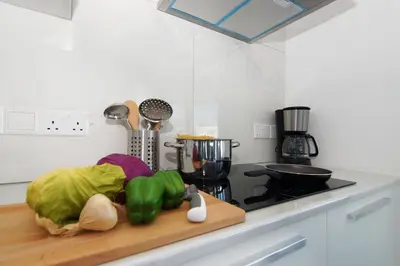 a kitchen counter with vegetables on a cutting board at Villa Theresa in Protaras