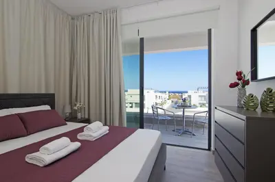 a bedroom with a large bed with towels on it at Villa Theresa in Protaras