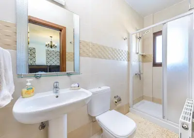 a bathroom with a sink and a toilet and a shower at Amani Villa in Protaras