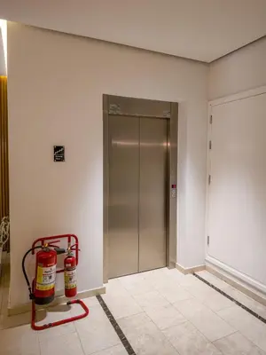 a room with two fire extinguishers in front of a elevator at City Centre Studio Apartments Nicosia in Nicosia