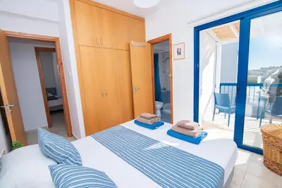 a bedroom with a bed and a large glass window at Villa Saint Nikolas in Protaras