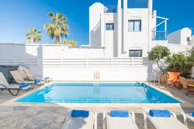 a swimming pool in front of a white house at Villa Saint Nikolas in Protaras