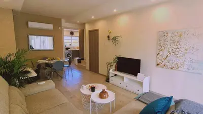 a living room with a couch and a tv at STAY Downtown Retreat in Limassol