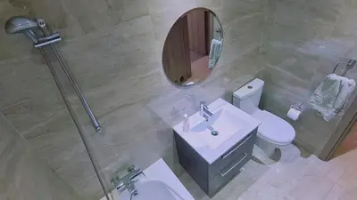 a bathroom with a toilet and a sink and a mirror at STAY Downtown Retreat in Limassol