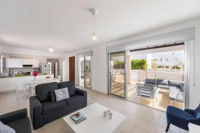 a living room with a couch and a table at Protaras Sapphire Seaside Villa in Protaras