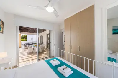 a bedroom with a bed with two towels on it at Protaras Sapphire Seaside Villa in Protaras