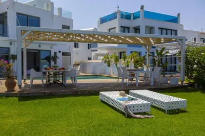 a backyard with a gazebo and a table and chairs at Beachfront Dream Villa in Protaras