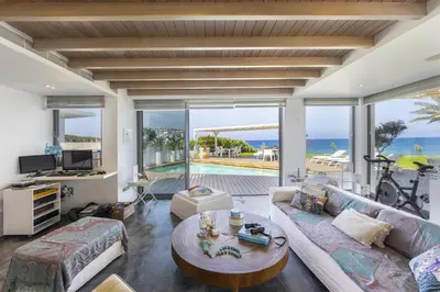 a living room with a couch and a table at Beachfront Dream Villa in Protaras