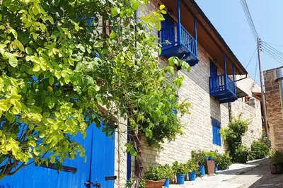 a building with blue doors and a blue fence at Arsos Nest in Arsos