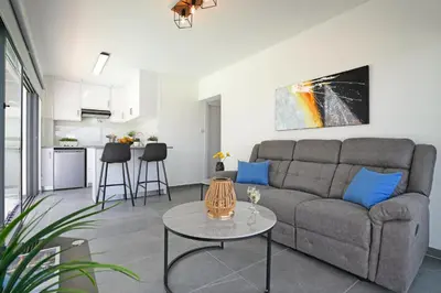 a living room with a couch and a table at Villa Royal View in Protaras