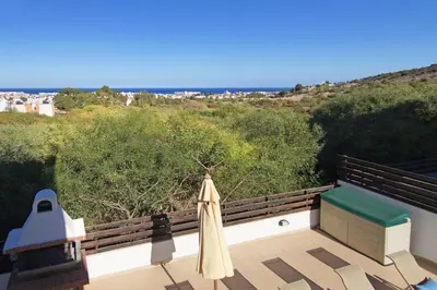 a patio with an umbrella and a view of the ocean at Villa Royal View in Protaras