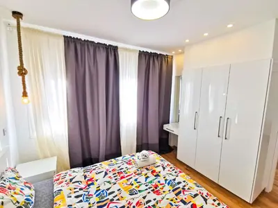 a bedroom with a bed with a colorful blanket at CityCenter Boutique Apartment in Larnaka