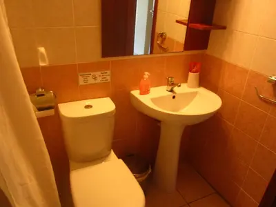 a small bathroom with a toilet and a sink at Marina Apartments 211 in Larnaka