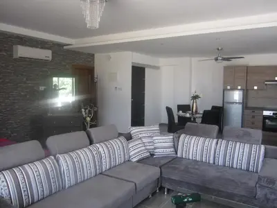 a living room with a couch and a kitchen at Marina Apartments 211 in Larnaka