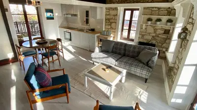 a living room with a couch and a table at Leonys House by TrulyCyprus in Doros