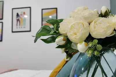 a vase with white flowers in it on a table at Pretty and quiet studio, with wifi and parking in Limassol