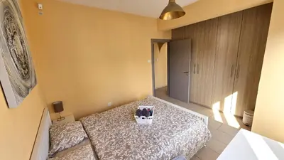 a bedroom with a bed with aactedacted at Spacious Lightflooded 2BR Apt / Near Center & Harbour in Larnaka