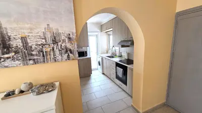 a kitchen with an archway leading into a kitchen with a city at Spacious Lightflooded 2BR Apt / Near Center & Harbour in Larnaka