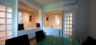 a dining room with a green table and a window at KALIDONIA RESIDENCE Suite Nicosia , Spacious 2 BR suite with office in Nicosia